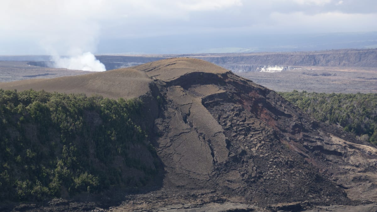 The solidified lava floor of Kilauea Iki crater ringed by rainforest, Hawaii Volcanoes National Park