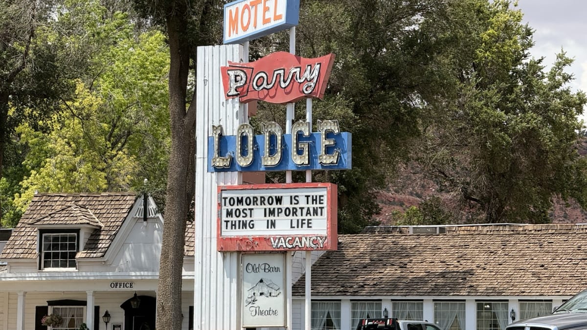 The vintage neon Parry Lodge motel sign and Old Barn Theatre marquee along Center Street in Kanab, Utah