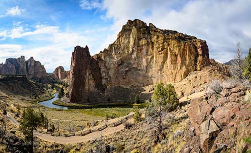 Smith Rock State Park in Central Oregon with dramatic volcanic rock formations rising above the Crooked River