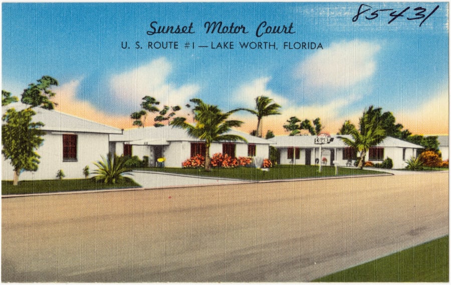 A vintage linen postcard of the Sunset Motor Court, a low white motor court with palm trees on U.S. Route 1 in Lake Worth, Florida