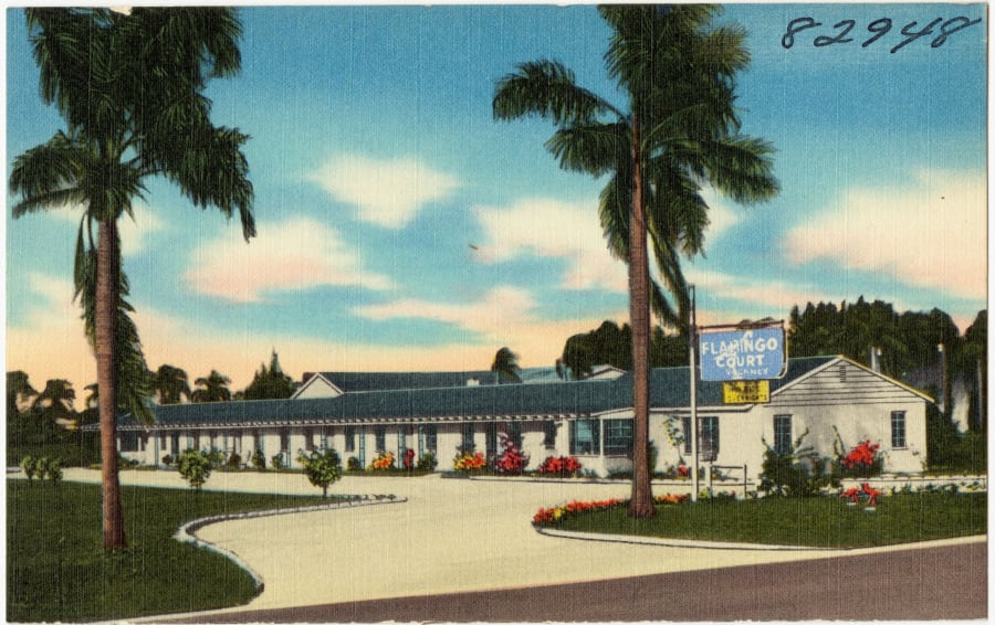 A vintage linen postcard of the Flamingo Court motel, its rooms under one long roof beneath a neon sign, in Clearwater, Florida