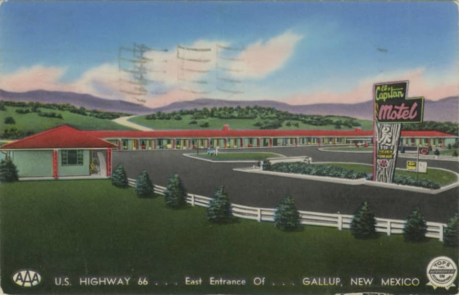 A 1950s color postcard of the El Capitan Motel in Gallup, New Mexico on Route 66, a single-story motor court with a curved neon sign and parked cars.