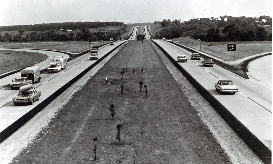 A 1967 black and white photograph of traffic on a divided Interstate 90 in rural Rock County, Wisconsin, near the Rock River.