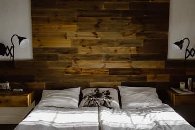 Dark wood feature wall in an affordable road trip motel room. Budget-friendly boutique stay with design intention