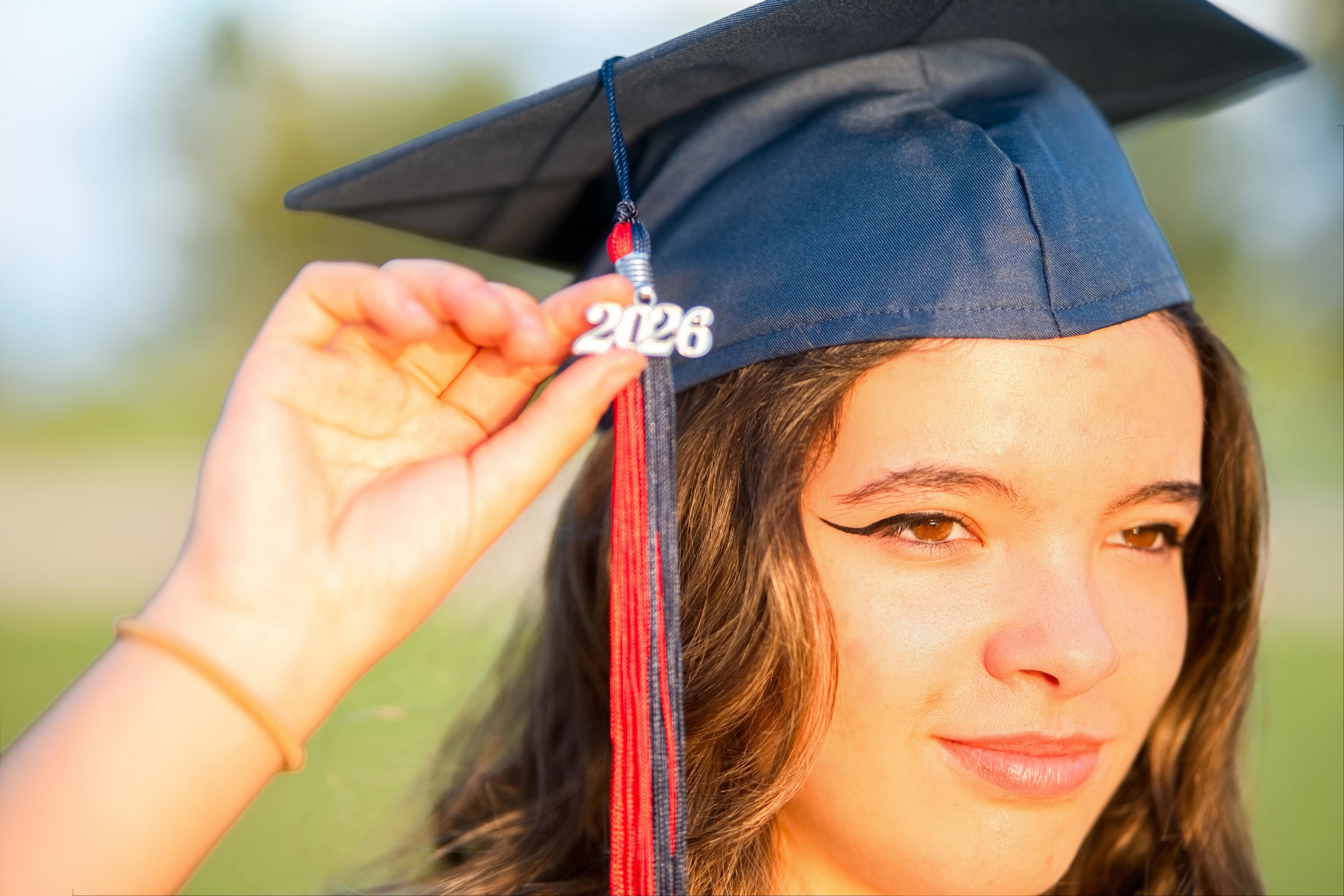 High school senior holding her 2026 graduation cap tassel