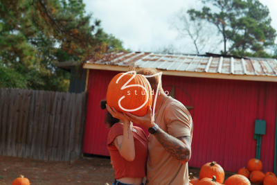 A smiling family poses among colorful autumn leaves for a fall portrait session in Pinehurst, TX.