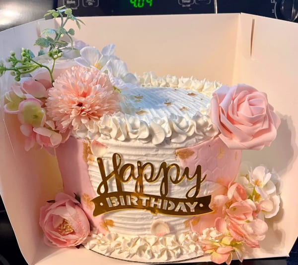 Elegant birthday cake adorned with fresh seasonal flowers by Christy's Cakes Whiteville NC