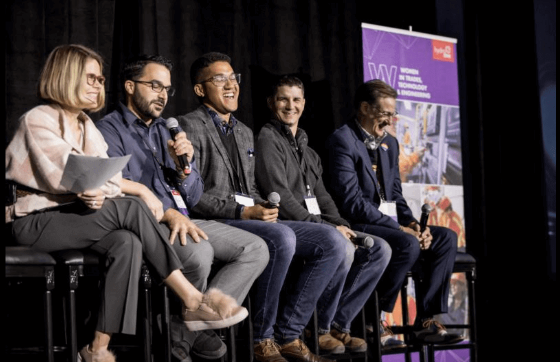 a group of men laughing on stage