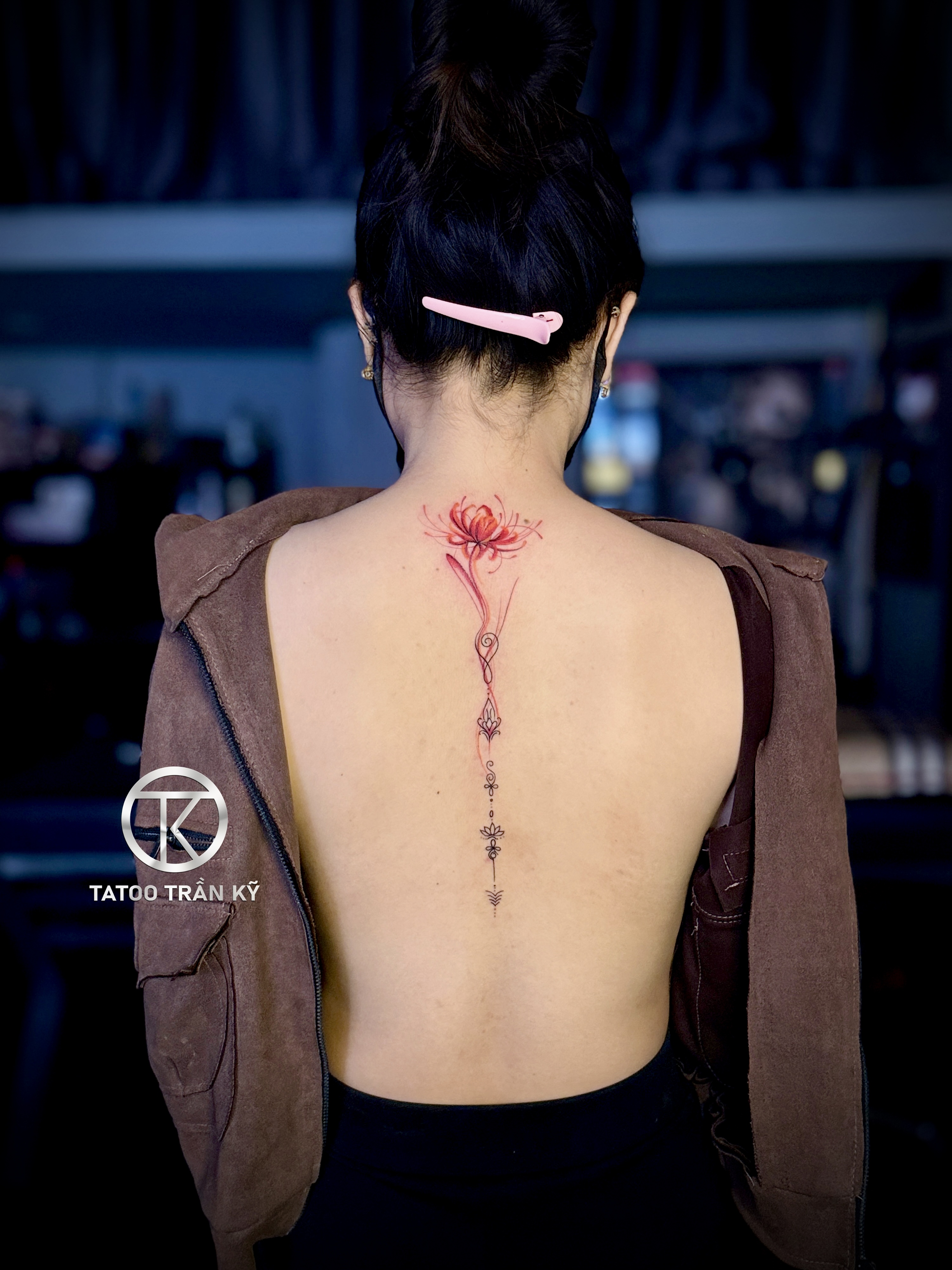 Flower tattoo along the back for women