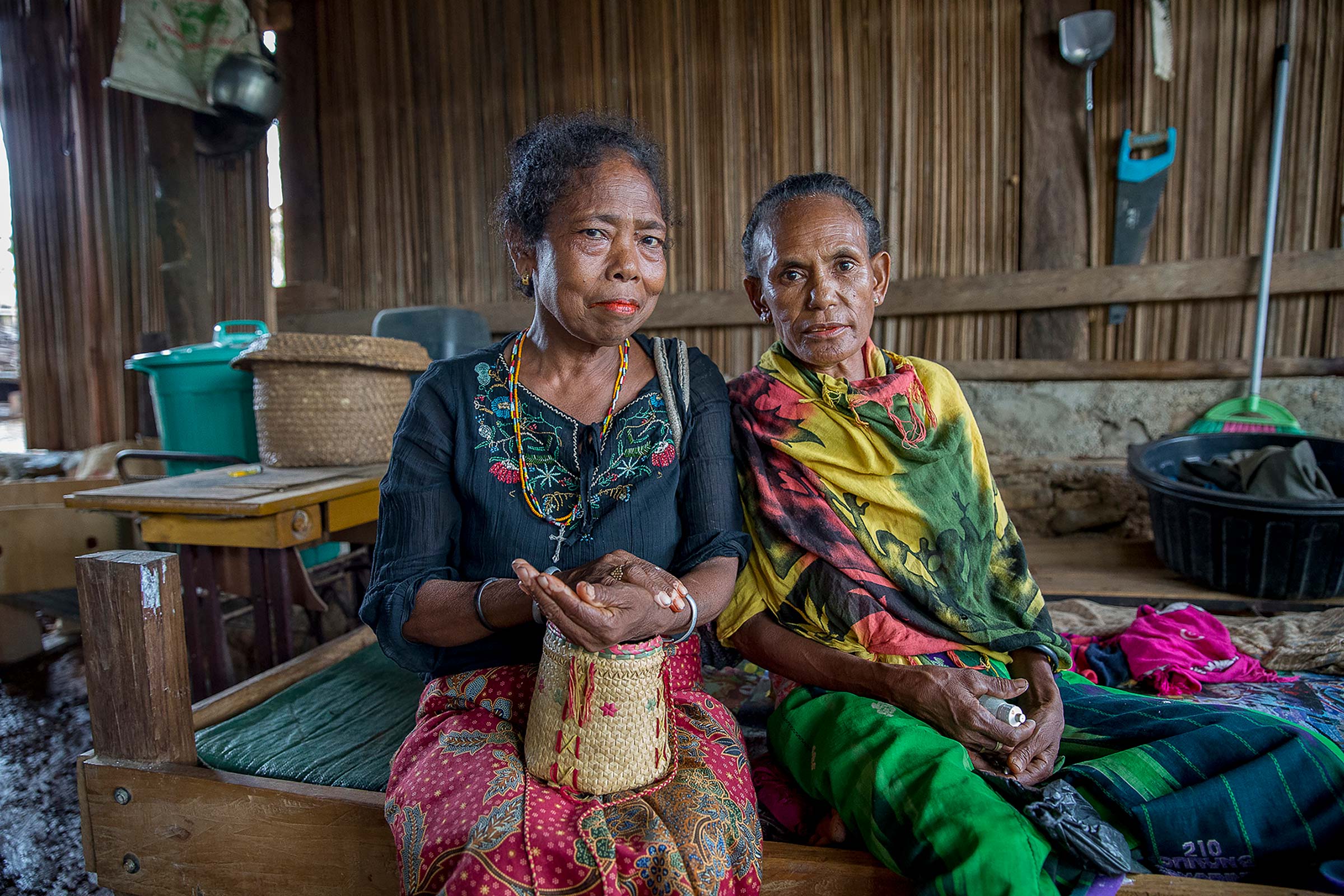 Photography by Anna Carlile, Creative Director, Women together holding basket. Located in Timor-Leste.
