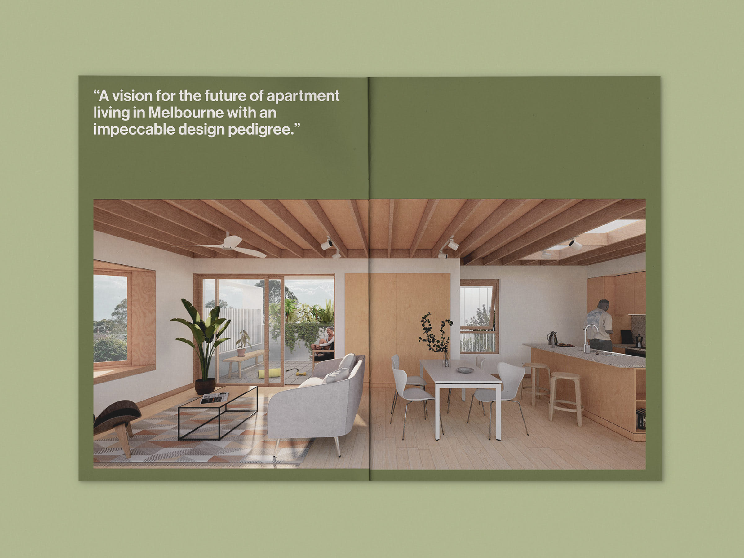 Spread view of brochure sitting on a green background. Large text runs above an architectural render of an apartment building, displayed over both pages.