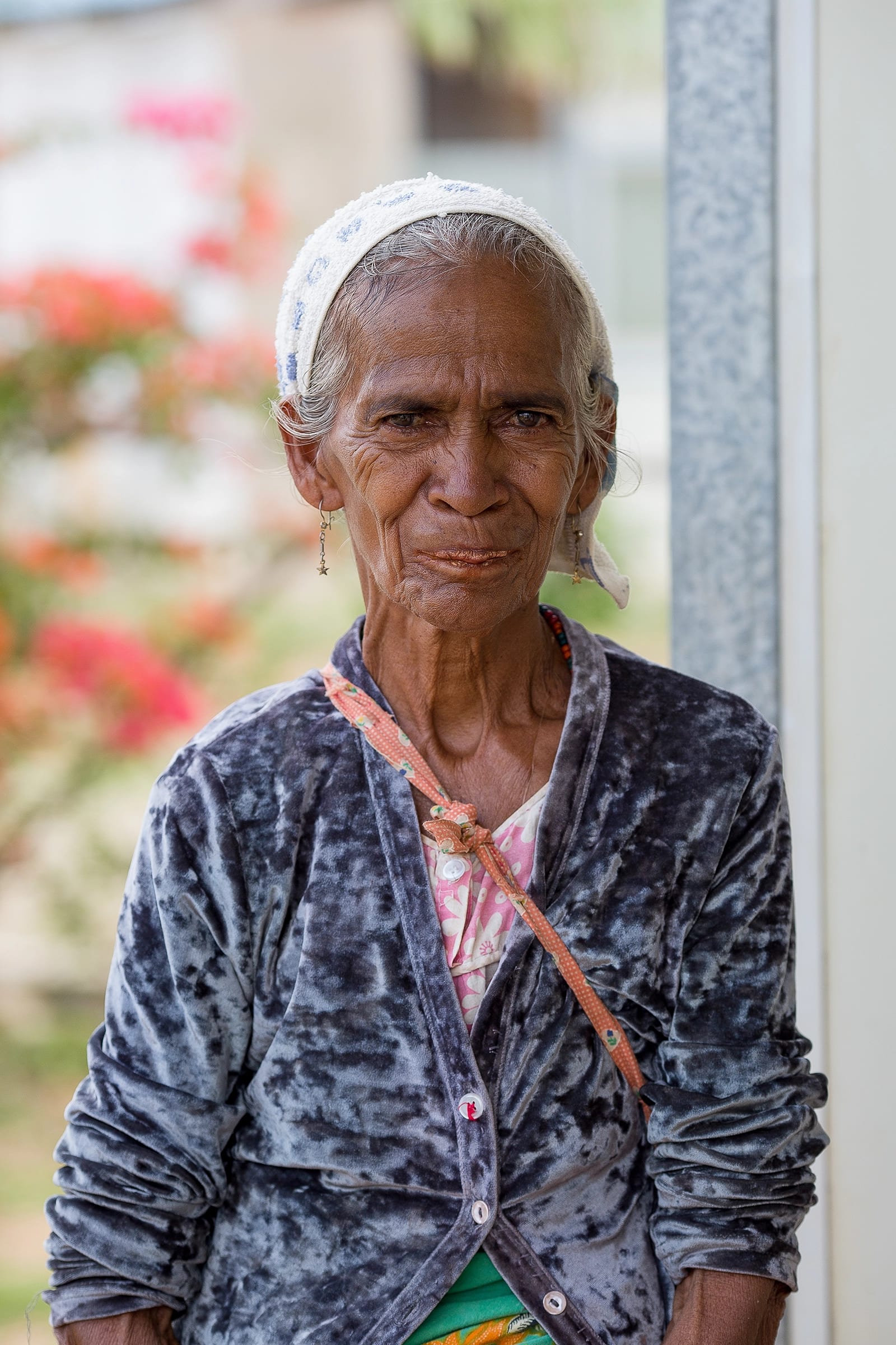 Older woman with headscarf looking into camera