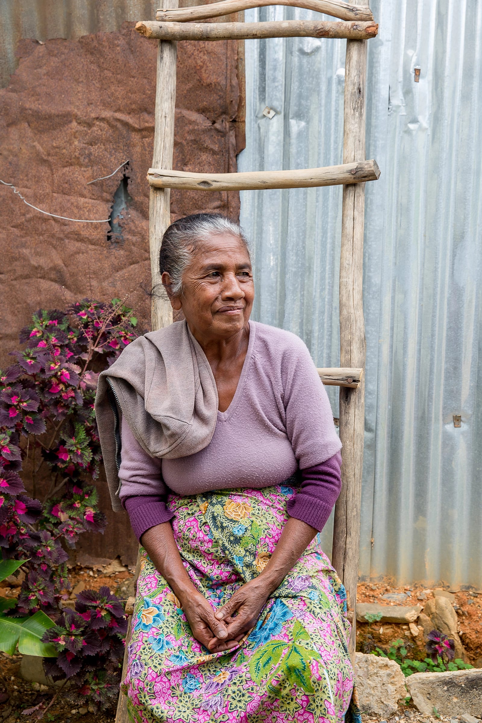 Colourful older woman sitting in Timor Leste