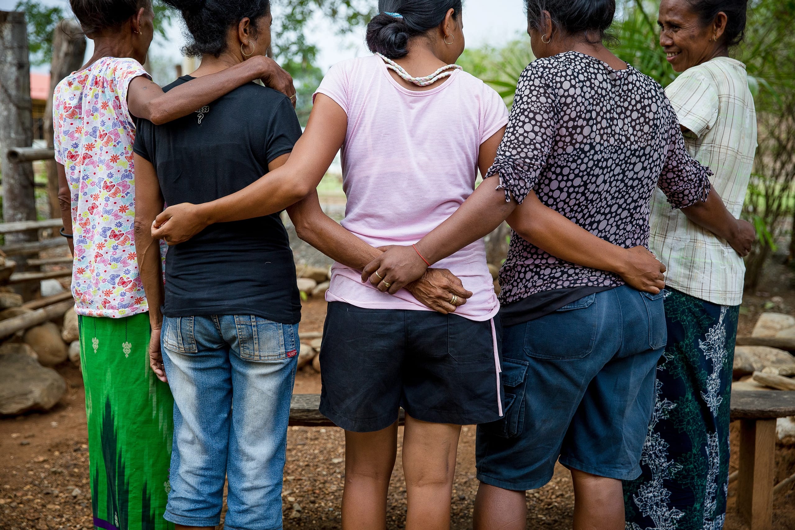 Group of women holding one another