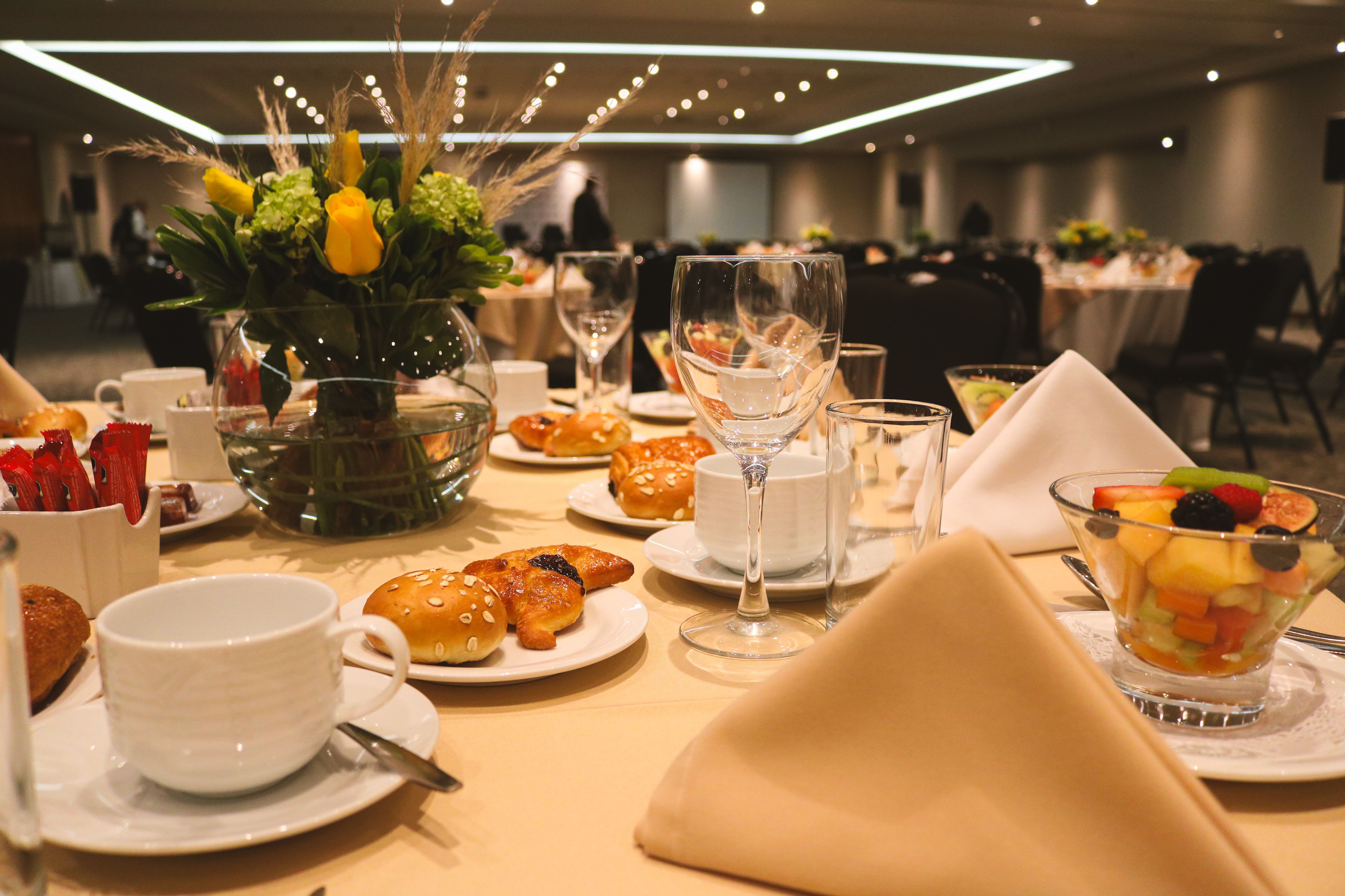 Elegant event venue with string lights and guests arriving for a gala evening celebration