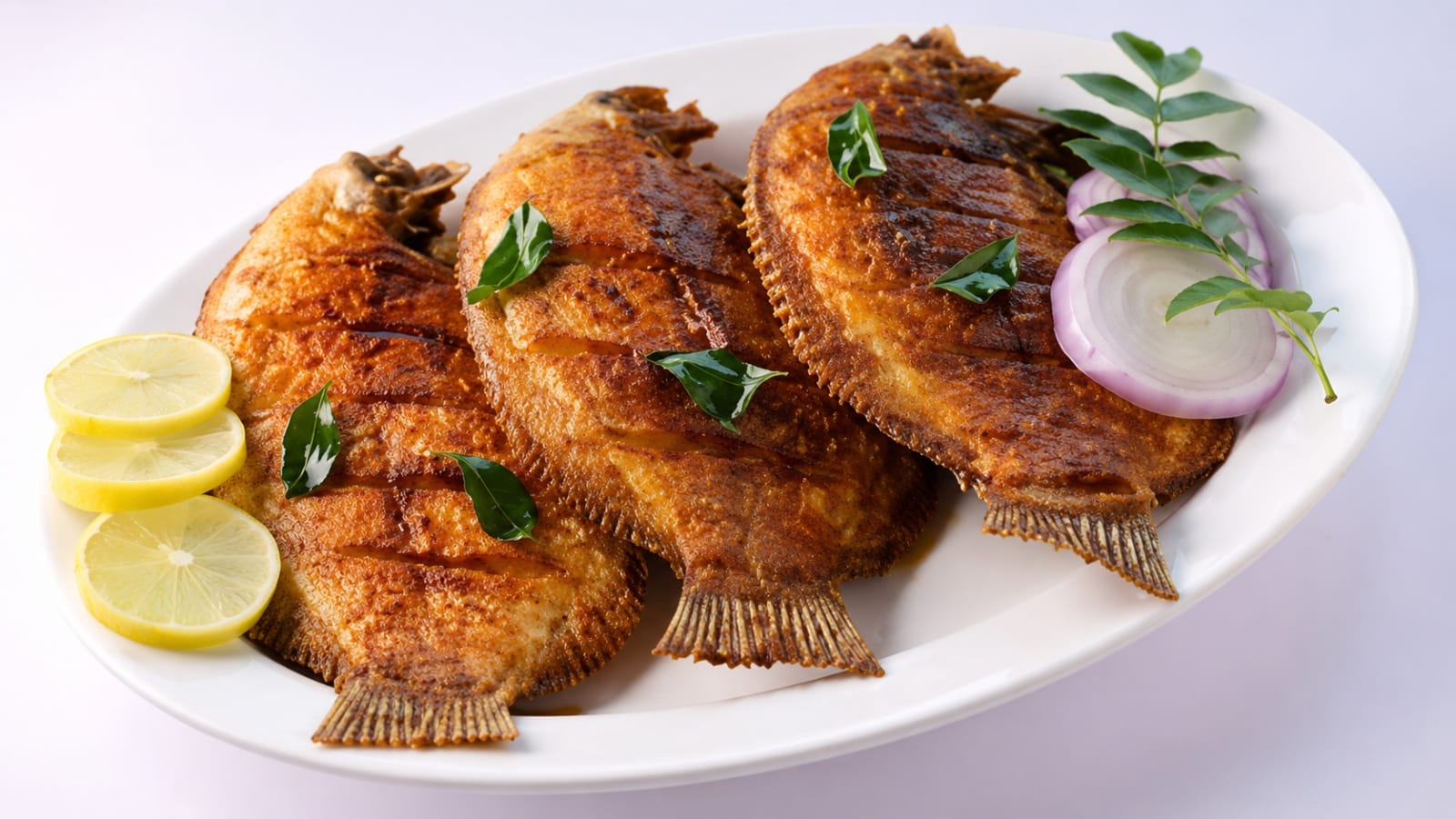 Karimeen pollichathu — Kerala pearl spot fish in banana leaf, the iconic Alleppey houseboat seafood dish