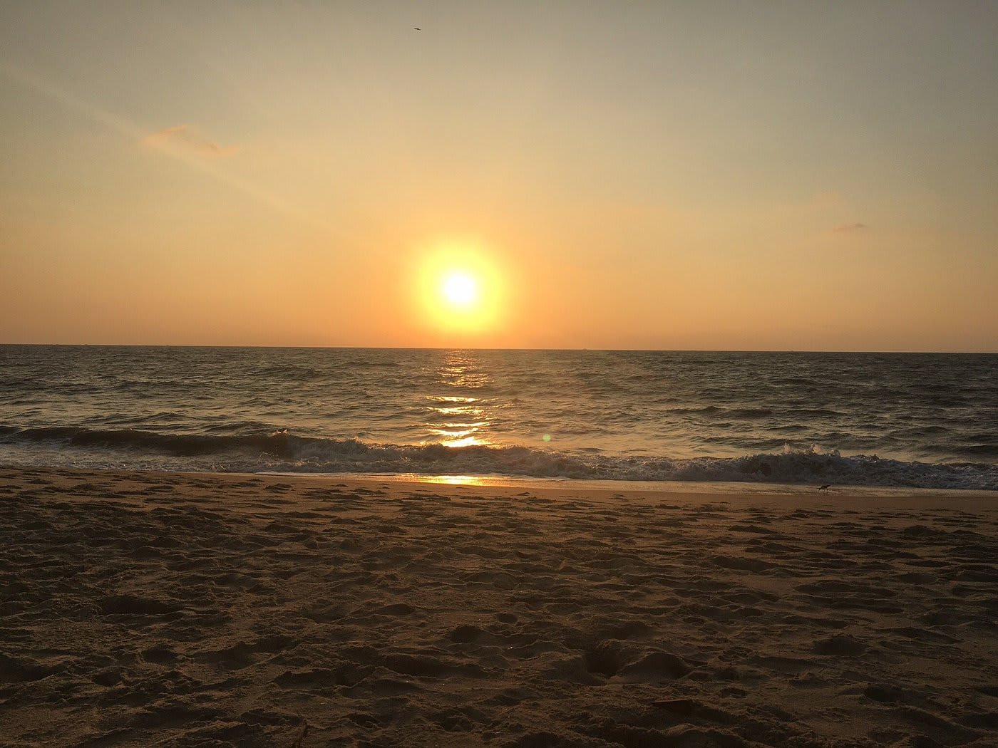 Sunset view at Marari Beach with waves and golden sky