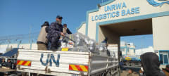 Hamas policemen guarding an aid truck as it reaches the UNRWA logistics base in Rafah