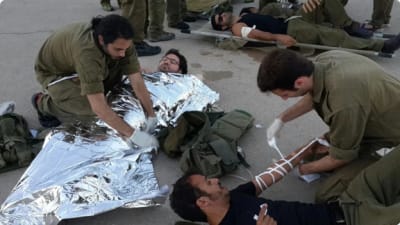 IDF soldiers providing aid to wounded Palestinians