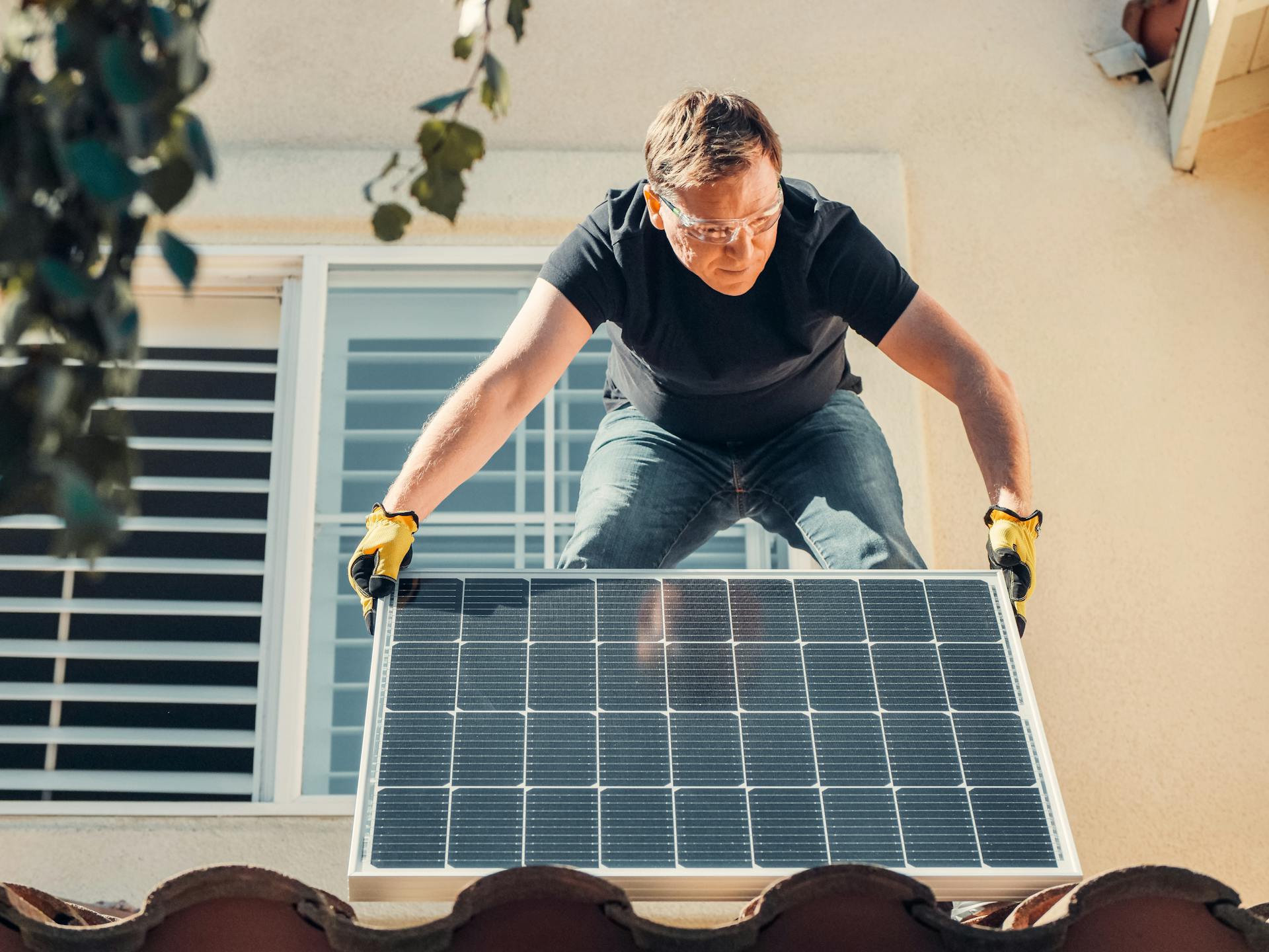 A man installing a solar panel.