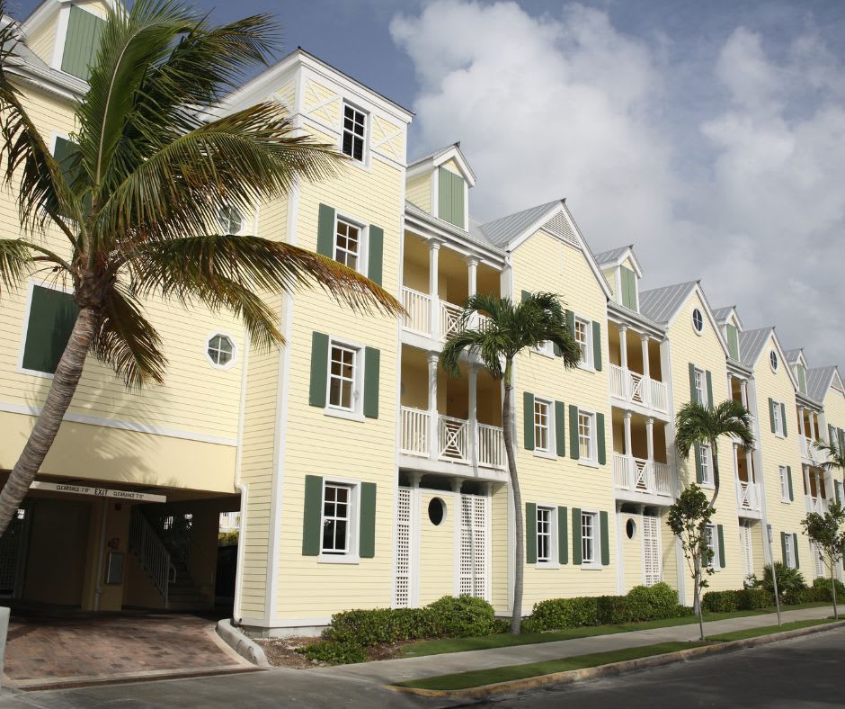 A row of white Miami townhomes seen during the day time.