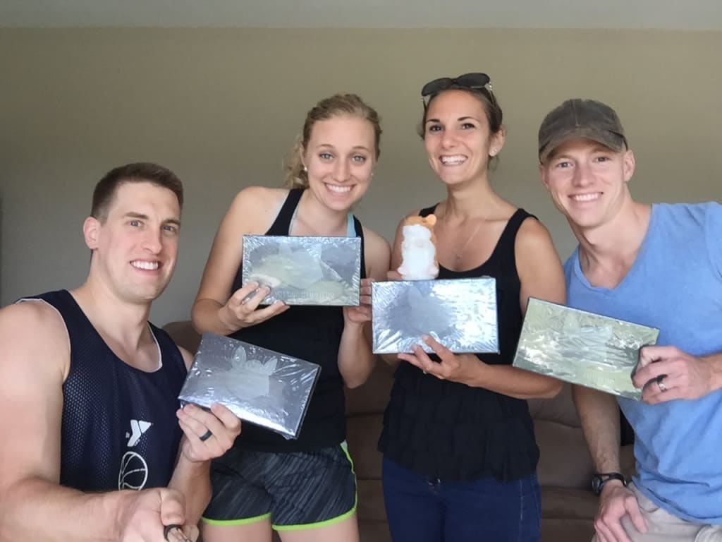 Alex and Rebekah Host and Andrew and Allison Gerbsch holding copies of Gyrating Hamsters