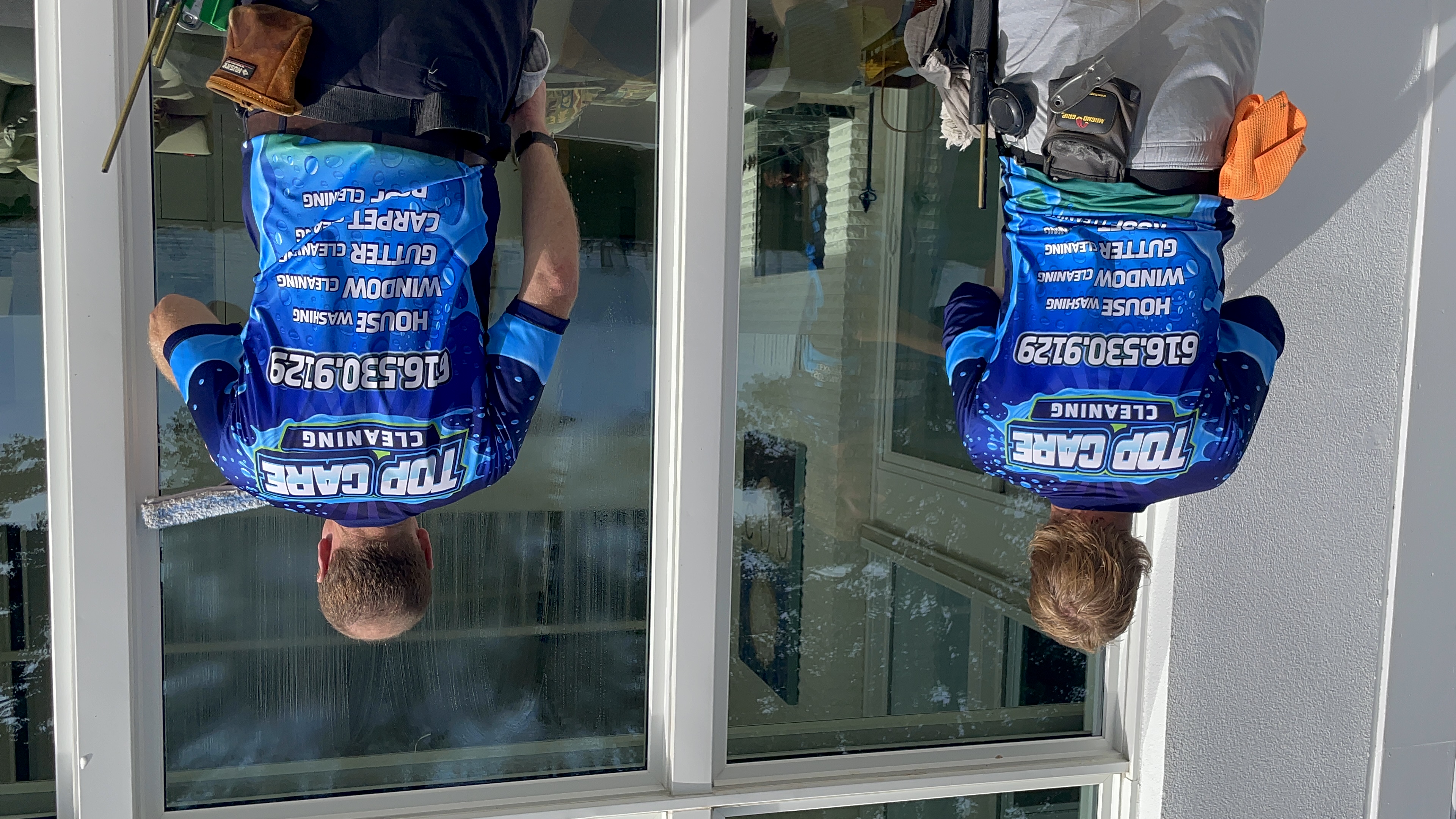 Top Care Cleaning window technicians on a job in Grand Rapids, MI