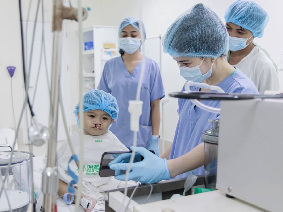 Doctor showing child their phone