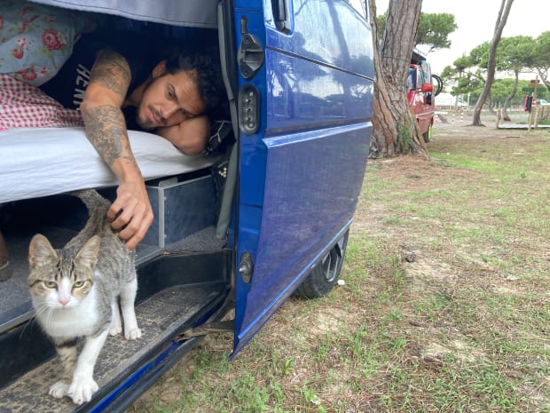 Playing with the kitten while lying in bed in the van