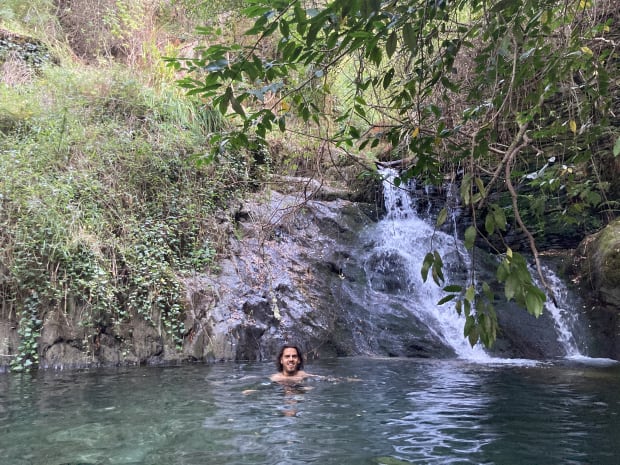 Me swimming in a waterfall splash pool