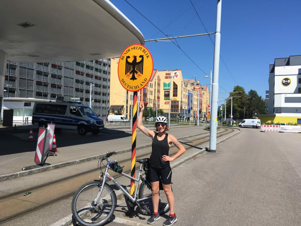 Rosalie standing under a German border crossing