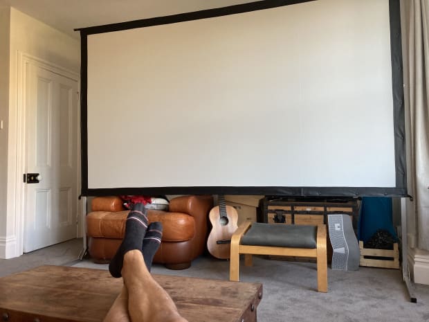 I set up the projector screen in our living room
