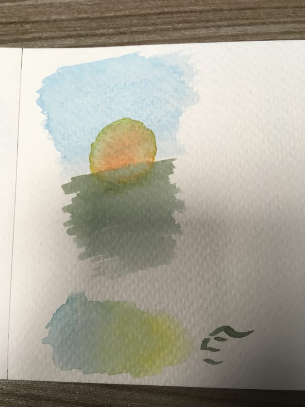 A bad watercolour painting of a setting sun