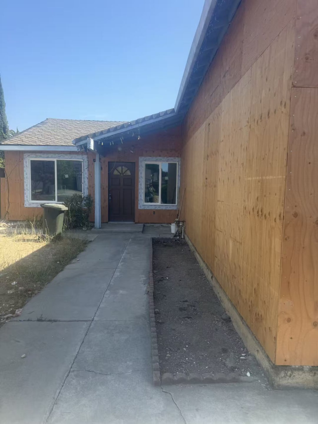 Completed exterior siding and driveway