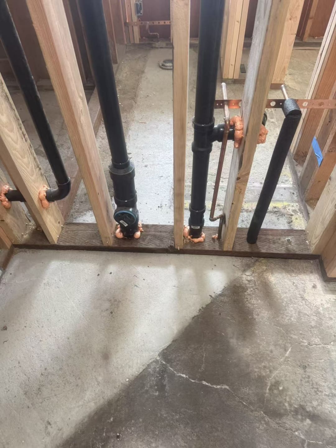 Copper supply lines run through framed wall