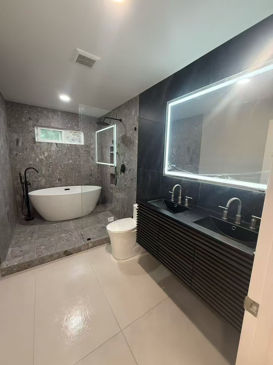 Dark modern vanity with backlit mirror