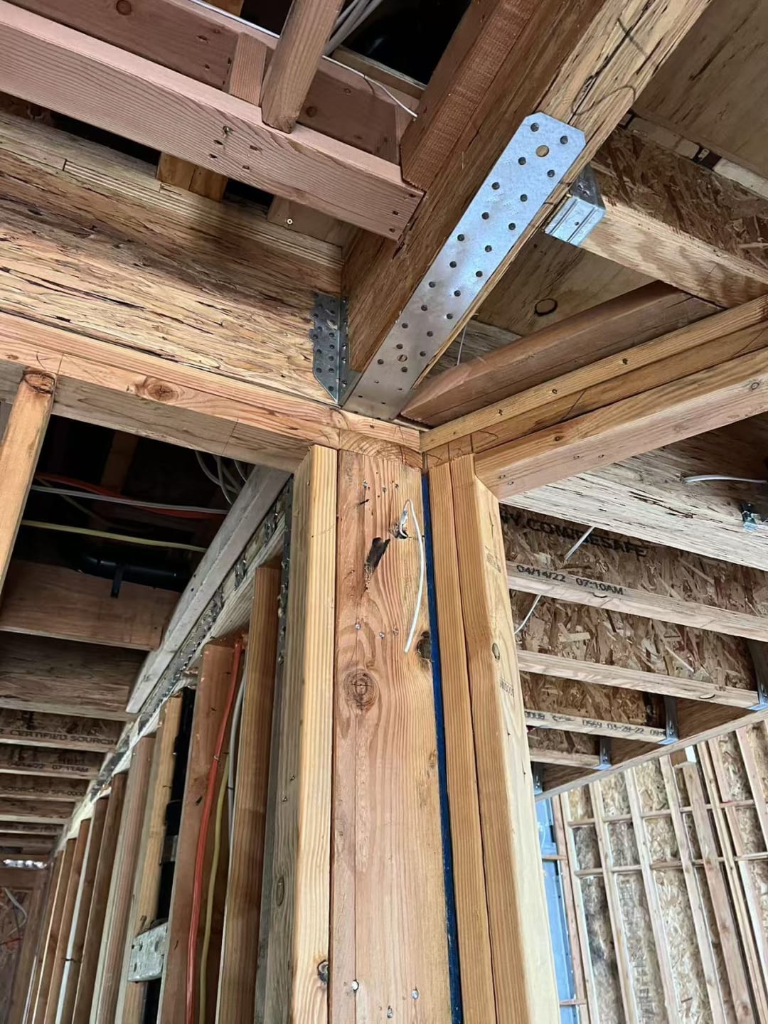 Metal joist hangers securing framing