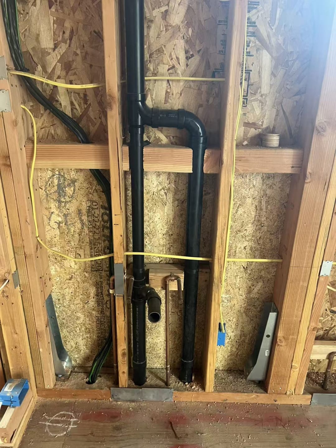 Stud wall marked for utility rough-in