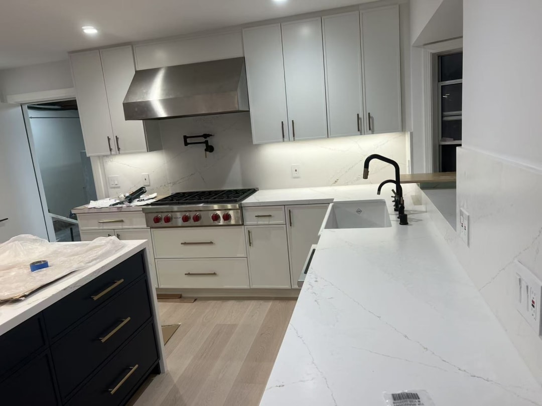 Kitchen with stainless range and hood