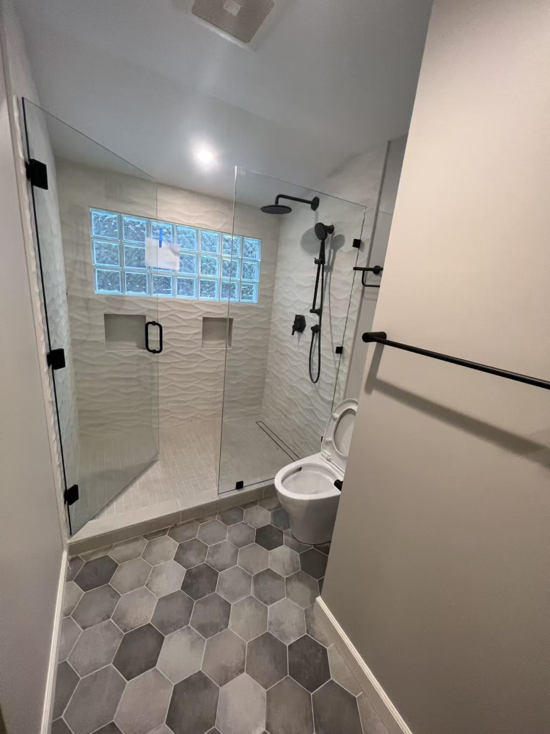 Corner shower with hex tile floor