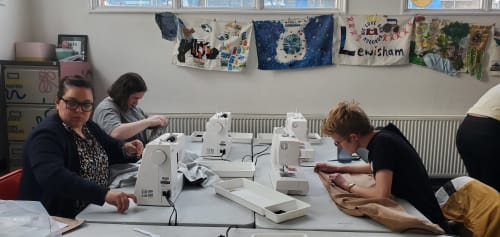 Students focussing on their sewing in our brightly-lit studio.