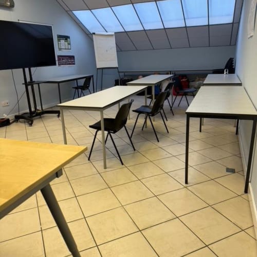 Marine training classroom at Seagrass Marine Oban Scotland for AEC and RYA courses with desks, screen and whiteboard supporting theory and practical learning.