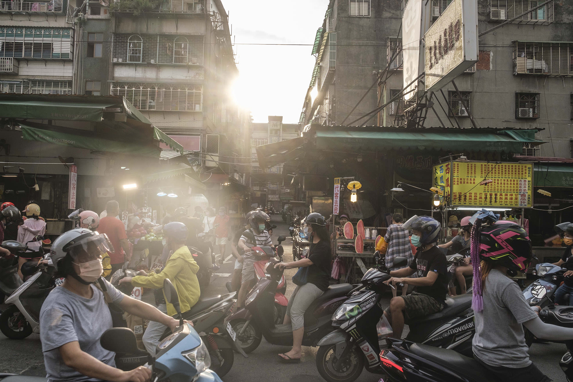 Taipei street scene showing people walking and on bikes.