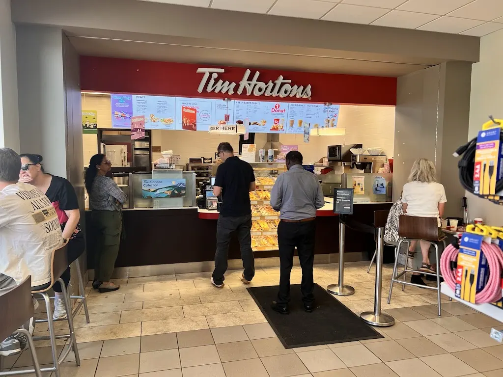 Tim Hortons storefront and interior at 411 Airport Rd, Edmonton International Airport, AB