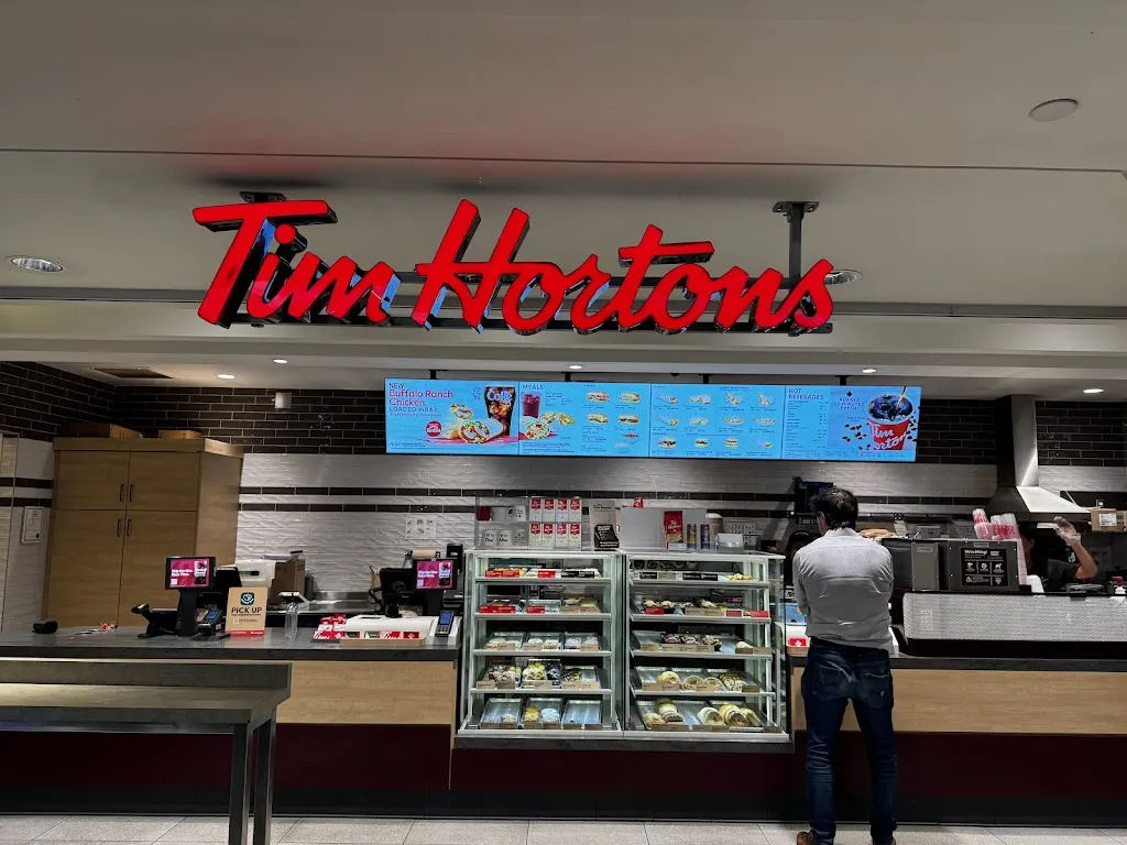 Tim Hortons storefront and interior at Ground Level - 1055 Georgia St W, Vancouver, BC