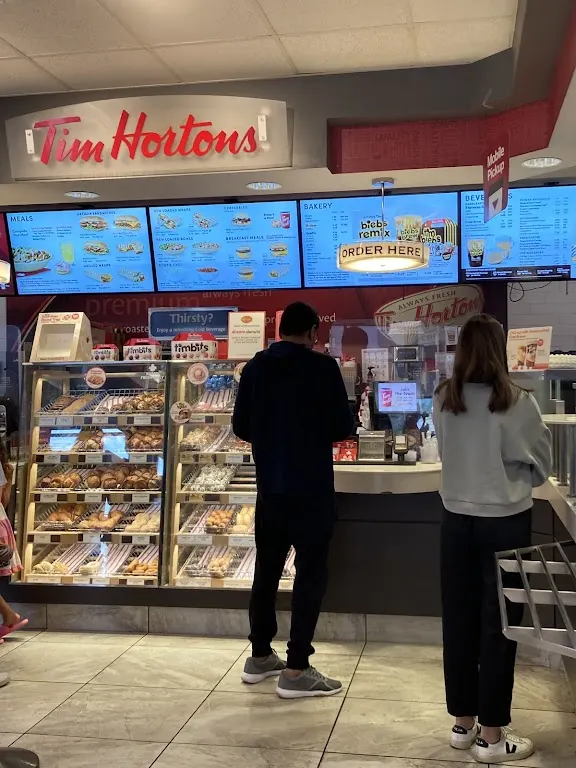 Tim Hortons storefront and interior at 5051 Harvester Rd, Burlington, ON