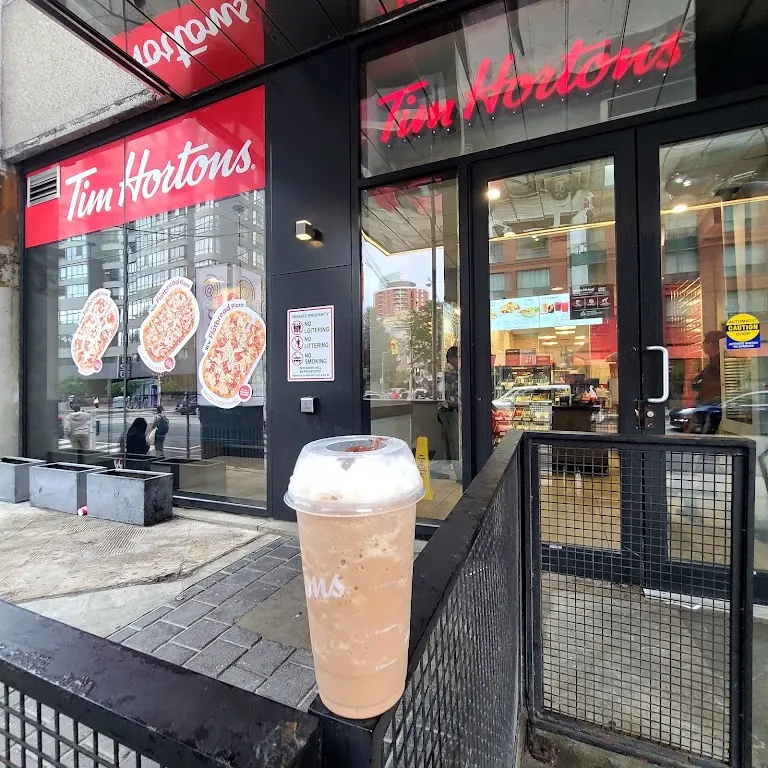 Tim Hortons storefront and interior at 111 Carlton St, Toronto, ON