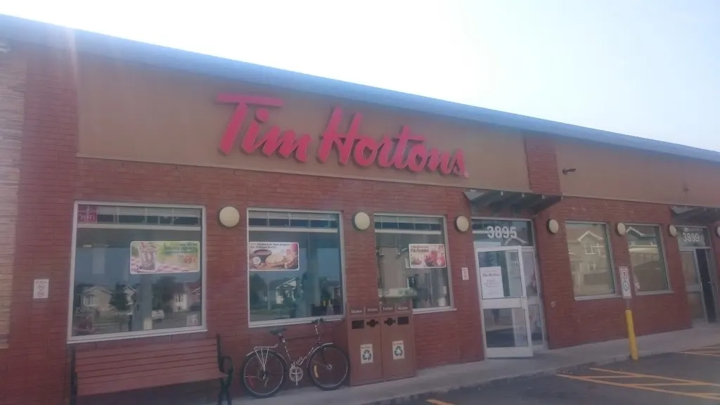 Tim Hortons storefront and interior at 3895 Rue Des Mouettes, Jonquiere, QC