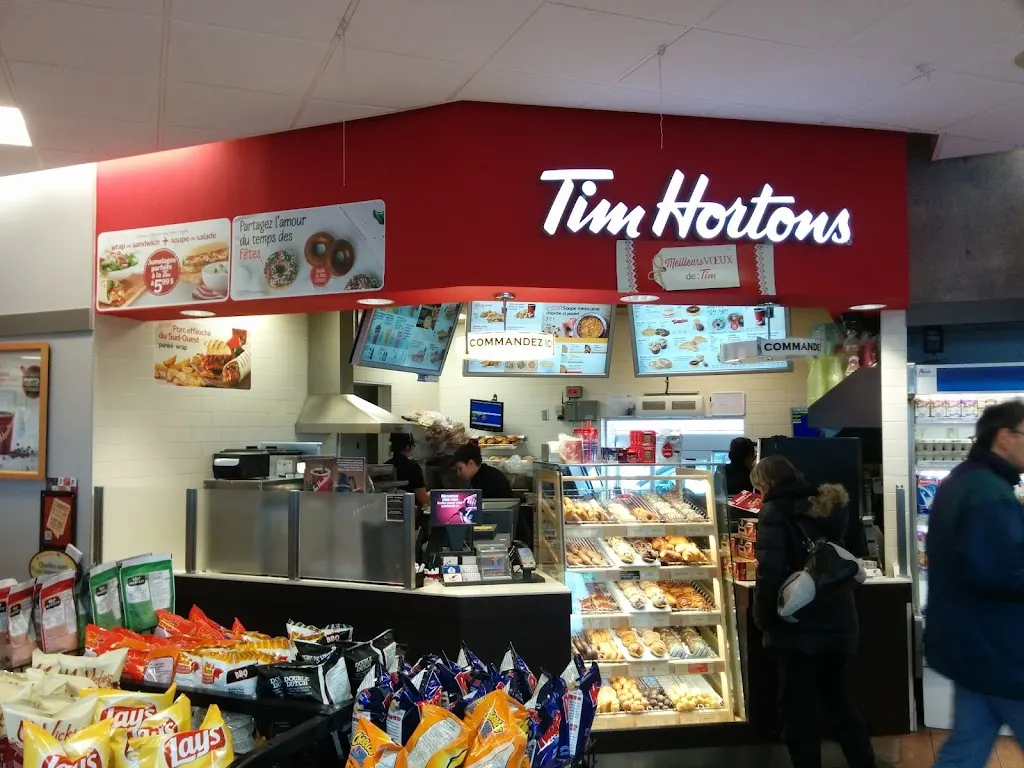 Tim Hortons storefront and interior at 310 Boul Roland-therrien, Longueuil, QC