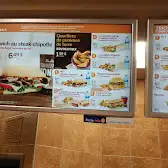 Tim Hortons storefront and interior at 2145 Boul Roland-therrien, Longueuil, QC